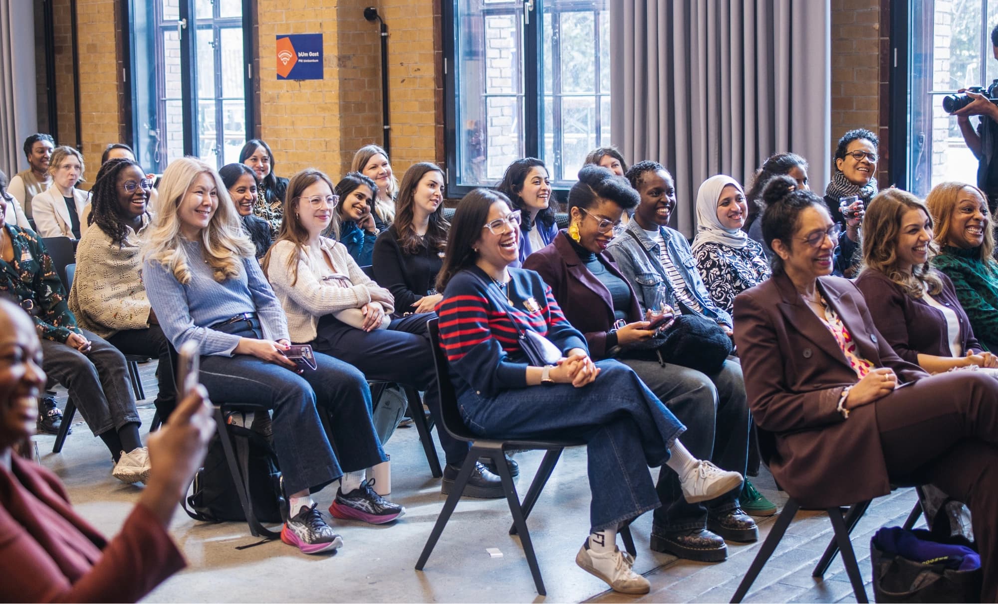 Women leaders gathered in a professional conference setting